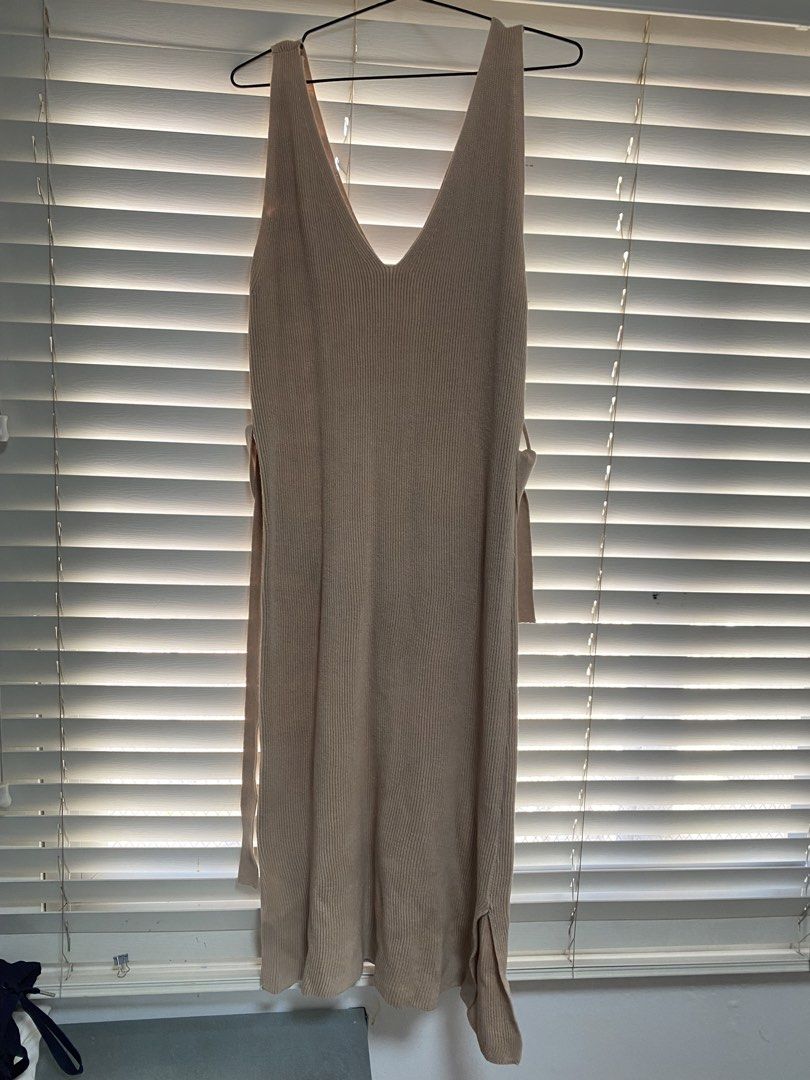 Beige Knit Dress with Tie (Category: Dresses) located in Cavite. Submitted by prelovedclothesofzoe (Listing ID 1436512834, Image 1). Description: Beige knit dress features a V-neck design and side slits. It includes tie details at the waist for an adjustable fit. The tag shows the number 93..