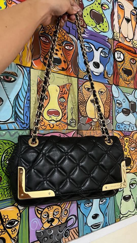 Black Quilted Shoulder Bag with Gold Accents (Category: Shoulder Bags) located in Makati City. Submitted by aiahscloset (Listing ID 1436629162, Image 3). Description: - Black quilted shoulder bag - Gold-toned chain straps - Gold accents - Smooth, leather-like material - Rectangular shape with flap closure - Suitable for everyday or special occasions.