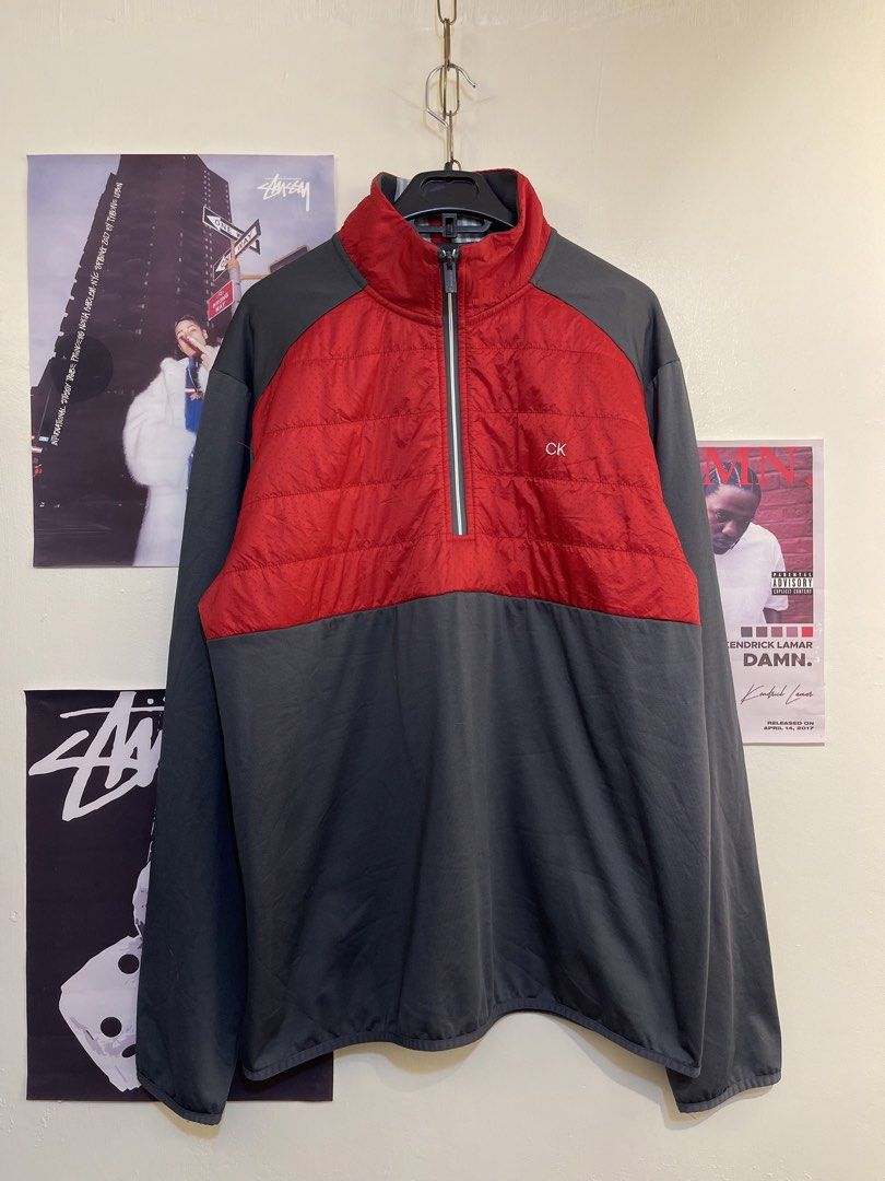 Calvin Klein Half-Zip Jacket (Category: Coats, Jackets and Outerwear) located in Tayabas. Submitted by stashsurplusph (Listing ID 1436576454, Image 1). Description: - Calvin Klein jacket - Red quilted upper panel - Gray lower panel - Half-zip closure - CK logo on chest - Long sleeves - High collar - Lightweight and perfect for layering.