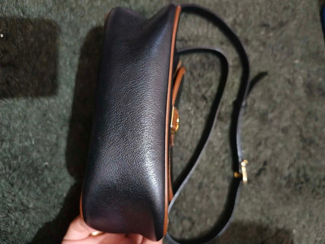 Celine crossbody Bag vintage (Category: Luxury Bags & Wallets) located in Baguio. Submitted by aishachangwook (Listing ID 1436585714, Image 3). Description: - Authentic Celine crossbody bag - Color: Black and brown - Features a flap closure with buckle vintage calfskin leather good condition fery nice - Brown leather trim - Gold-tone buckle - Celine logo visible - Includes a black shoulder strap - Material: Leather BAGUIO CITY LOCATION.