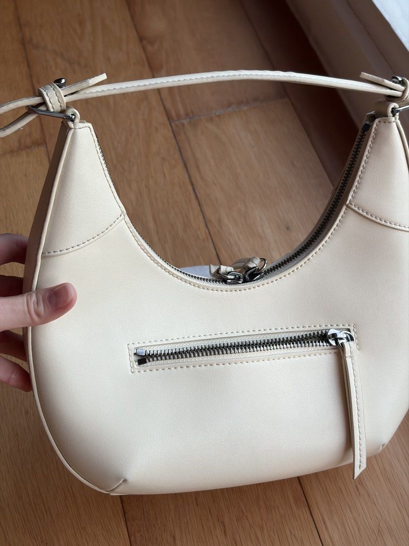 Charles & Keith beige bag original (Category: Shoulder Bags) located in Mandaluyong City. Submitted by vickydeclutter (Listing ID 1436567274, Image 3). Description: - last price 1000 Rfs don’t use it Charles & Keith crescent bag - Cream color - Top handle and additional strap - Silver-tone hardware - Zipper closure - Small zipper pocket at the back -barley used Got it in Powerplant!.