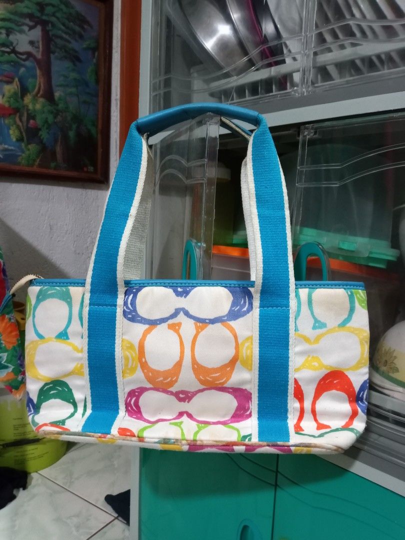Coach Multicolor Tote Bag (Category: Luxury Bags & Wallets) located in Manila. Submitted by caaths_collection (Listing ID 1436631906, Image 2). Description: PLEASE READ - Coach multicolor tote bag - Blue handle and trim - Front pocket - Zipper closure - Please check all photos for the bag's condition. It has some issues but it's still usable. Selling as is. - need clean po if u want - no refund & return policy - Perfect for everyday use - prelove