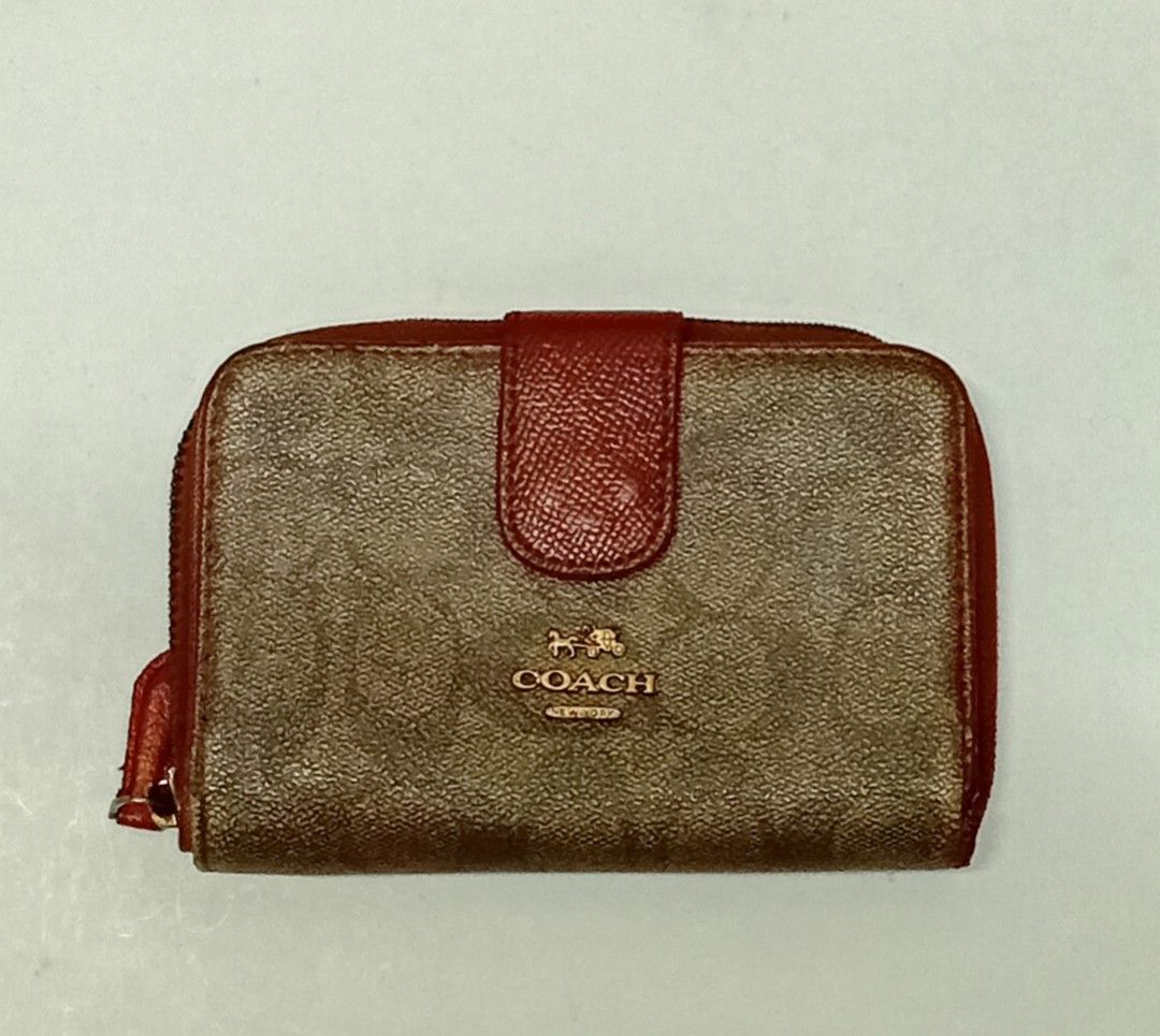 Coach Signature Zip Around Wallet (Category: Luxury Bags & Wallets) located in Navotas City. Submitted by riyuwi (Listing ID 1436625275, Image 1). Description: PREOWNED WellUsed Coach wallet with signature print - Zip-around closure - Red accents on flap and zipper - Multiple card slots - Clear ID window - Compartments for cash and essentials - Brown and red color scheme Off /Legit Sign of Used Good Condition 8.8/10.