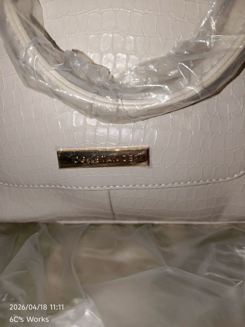 Constance Handbag White (Category: Luxury Bags & Wallets) located in Consolacion. Submitted by mencytte (Listing ID 1436649071, Image 3). Description: - Constance white handbag - Crocodile-skin texture - Gold-colored hardware - Top handle and detachable shoulder strap - Double zipper closure - Brand name detail.