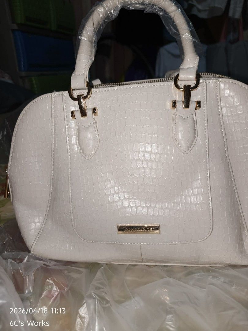 Constance Handbag White (Category: Luxury Bags & Wallets) located in Consolacion. Submitted by mencytte (Listing ID 1436649071, Image 1). Description: - Constance white handbag - Crocodile-skin texture - Gold-colored hardware - Top handle and detachable shoulder strap - Double zipper closure - Brand name detail.