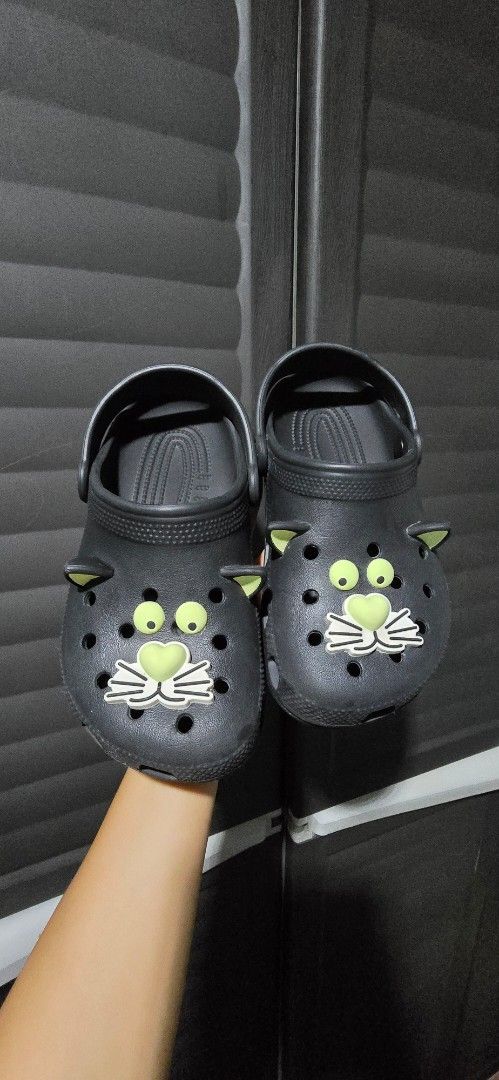 Crocs Black Cat Sandals (Category: Flats & Sandals) located in Manila. Submitted by muliph (Listing ID 1436477150, Image 3). Description: - Size J2 - Black Crocs sandals glow in the dark - Adorable cat design - Closed-toe design with ventilation - Secure back strap - Textured soles for grip .