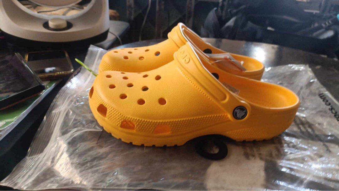 Crocs Classic Clogs - Yellow - Size W8/M6 (Category: Slippers & Slides) located in Manila. Submitted by bukid (Listing ID 1436557679, Image 2). Description: - Authentic Crocs Classic Clogs - Vibrant yellow color - Size: W8/M6 - Made in Vietnam - Classic design with ventilation ports - Perfect for casual wear - Easy to clean - Comes with original tag.