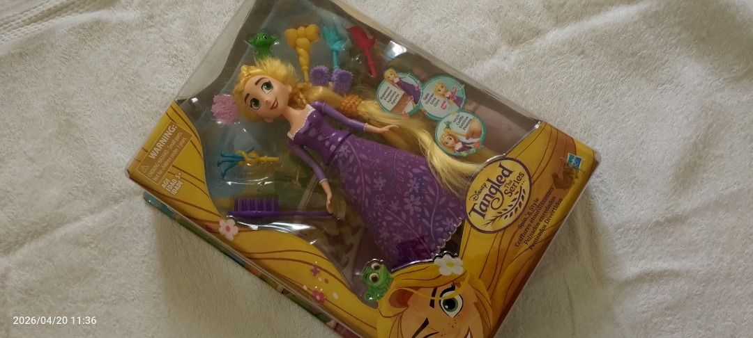 Disney Tangled Series Rapunzel Doll (Category: Figurines & Statues) located in Caloocan City. Submitted by carylpangi13052 (Listing ID 1436492264, Image 1). Description: - Disney Tangled Rapunzel doll - In original packaging - Includes hair clips and brush - Features Rapunzel in a purple dress - Box includes Tangled logo and Rapunzel images.