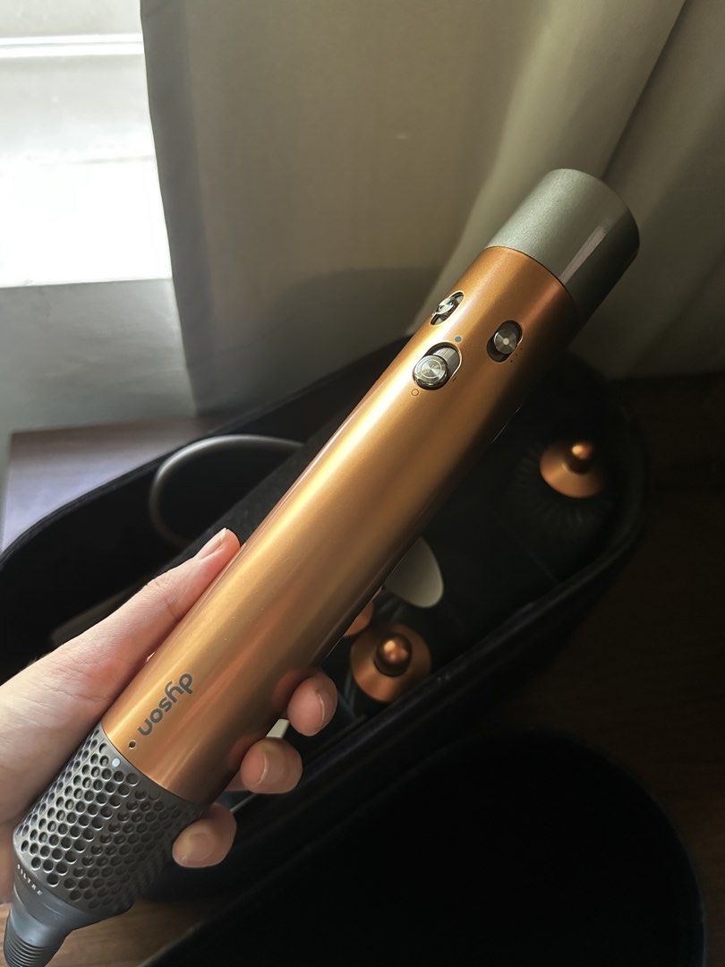 Dyson Airwrap Complete Copper (Category: Hair) located in Makati City. Submitted by jin.ramen (Listing ID 1436518813, Image 2). Description: - Dyson Airwrap Complete (Copper) - Attachments included - Comes with a convenient storage case. - Strictly for meet ups around Makati area - Authentic!! can be registered sa app for warranty RFS: not using it anymore. declutter slightly negotiable.