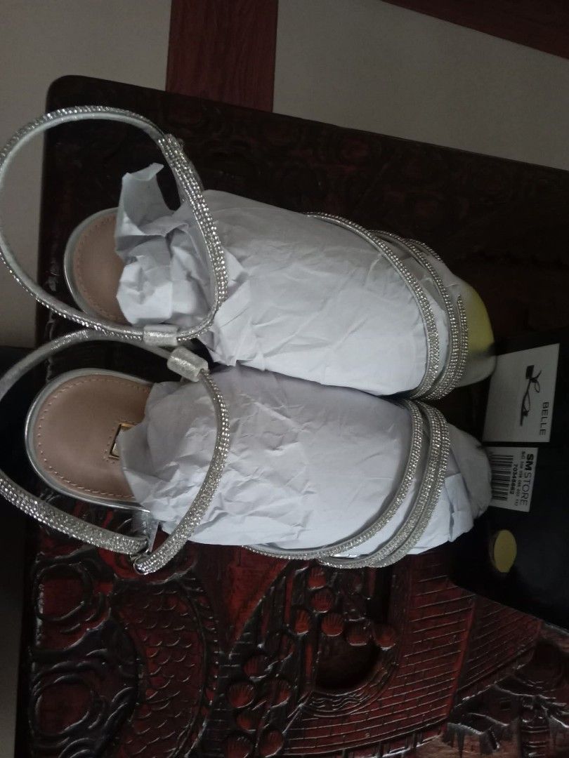 Figlia Belle Heel Sandals - Silver (Category: Heels) located in Manila. Submitted by dionayap (Listing ID 1436642975, Image 3). Description: Figlia Belle Heel Sandals in silver. Features a strap design with embellishments. The sandals have a low heel. The original price is ₱1,499. The item is new and comes with the original box. For sale po ‼️ • Size 36 • Used once, hindi pa buong araw nagamit • Selling price - 900 - Figlia Belle heel sandals in 