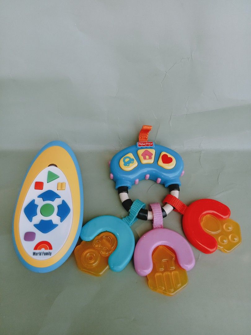 Fisher-Price and World Family Baby Toy (Category: Toys & Games) located in Rosario. Submitted by elysedeclutter (Listing ID 1436475148, Image 1). Description: - Fisher-Price baby toy designed for babies and toddlers. - Includes a remote control with colorful, shaped buttons. - Comes with a set of keys in different colors and shapes. - Features a convenient loop for easy carrying..