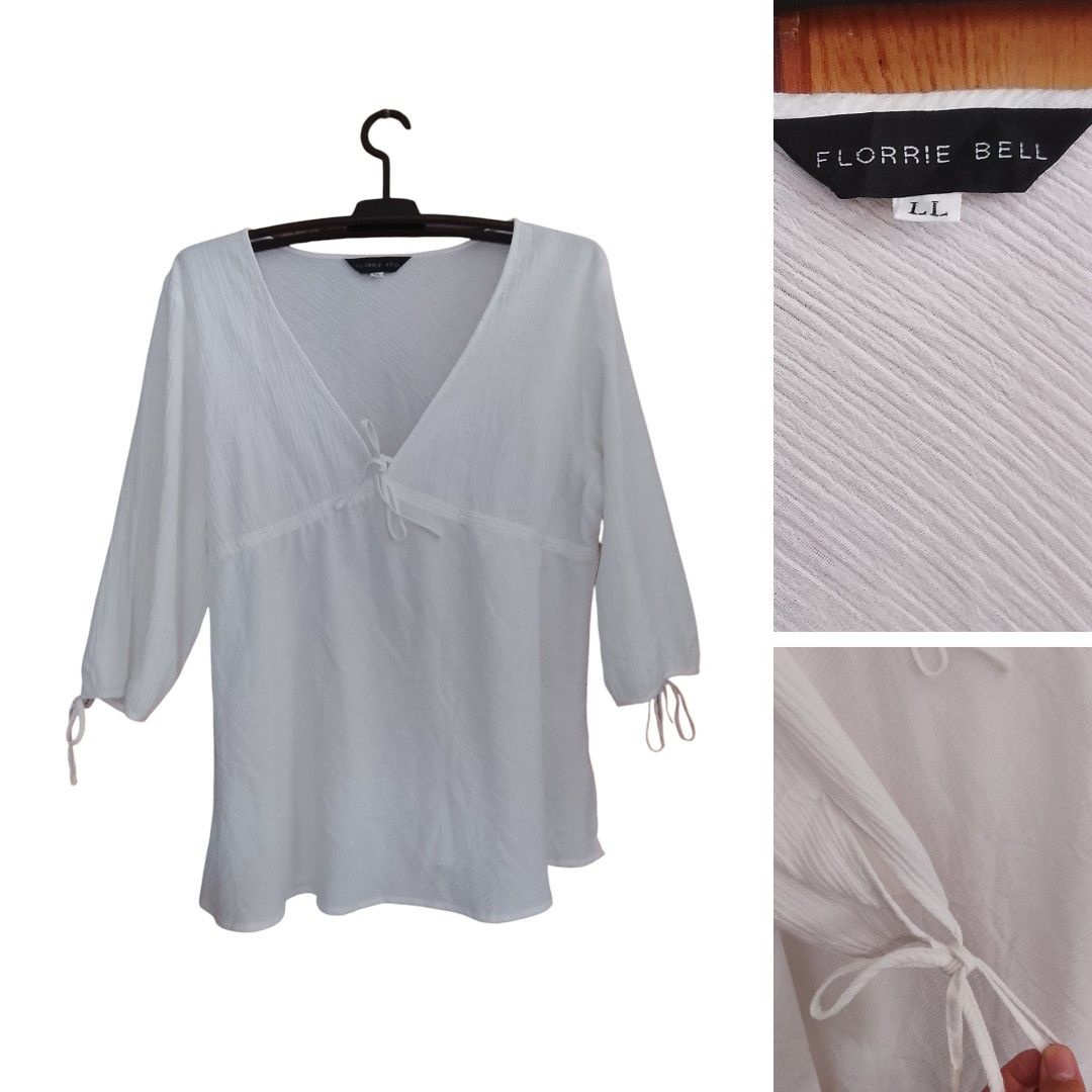 Florrie Bell White V-Neck Blouse LL (Category: Blouses) located in Manila. Submitted by elanie_closet_collection (Listing ID 1436589238, Image 1). Description: - Florrie Bell white blouse - V-neck design - Three-quarter sleeves with tie cuffs - Gathered detail under bust - Tie detail at neckline - Size: LL.