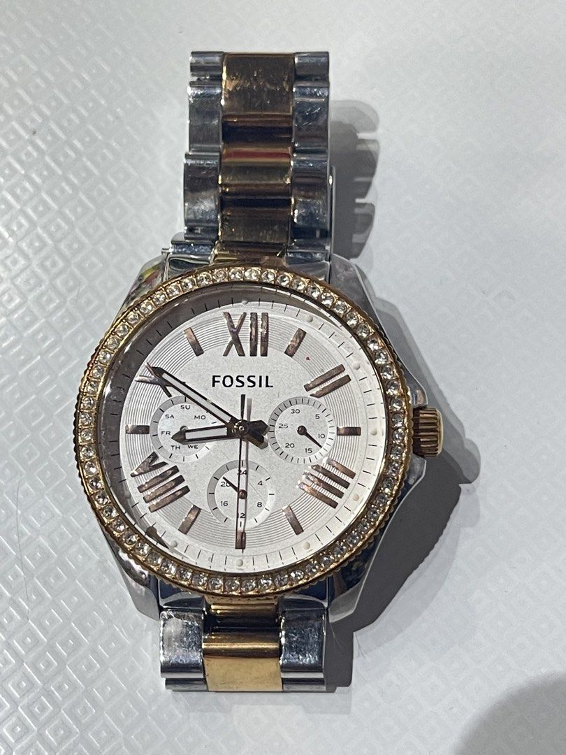 Fossil Watch with Gold Accents (Category: Women's Watches) located in Binangonan. Submitted by chasechloe (Listing ID 1436499041, Image 1). Description: Fossil AM-4496 - Fossil watch with a silver dial. - Gold-tone hands and Roman numeral hour markers. - Gold-tone bezel with crystal accents. - Stainless steel band with gold-tone links. - Includes three sub-dials and a date display. - Perfect for everyday wear. MOD: - LBC (COD/COP with downpayment