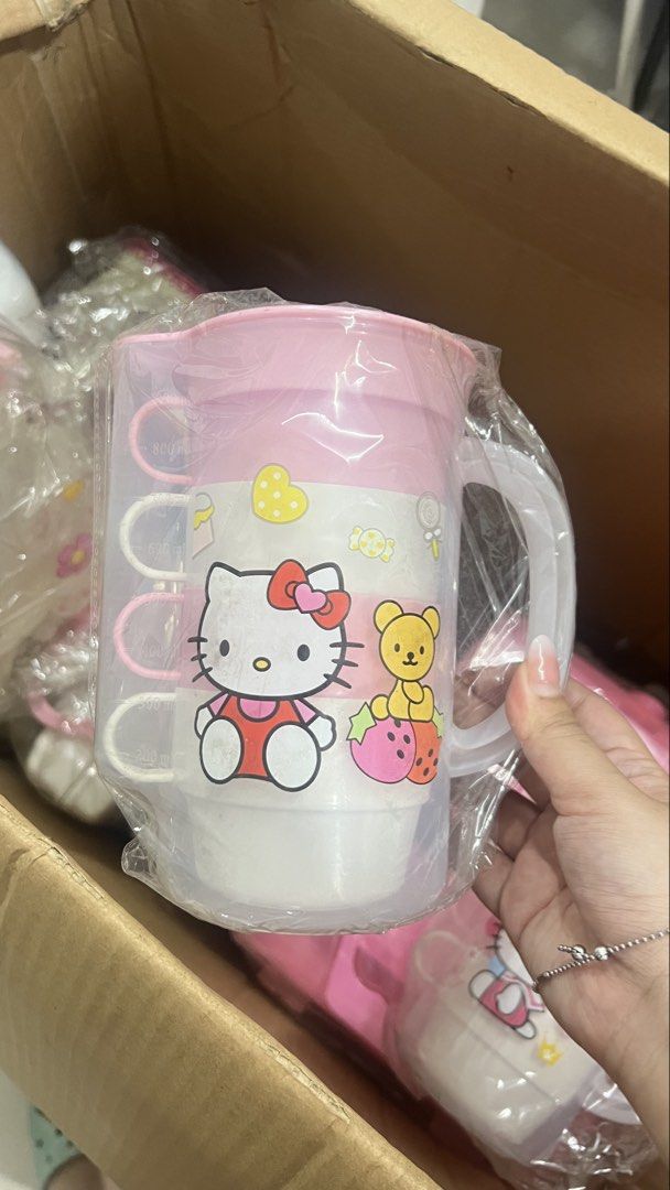 Hello Kitty Pitcher Cup Set (Category: Coffee & Tea Tableware) located in Manila. Submitted by machib (Listing ID 1436589746, Image 1). Description: - Kitty drinkware set - Includes: Pitcher with lid and 3 stackable cups - Features: Pink and white color scheme with Kitty designs - Pitcher: Has a handle - Cups: Have handles - Condition: Brand new, still in original packaging - have 3pcs available.