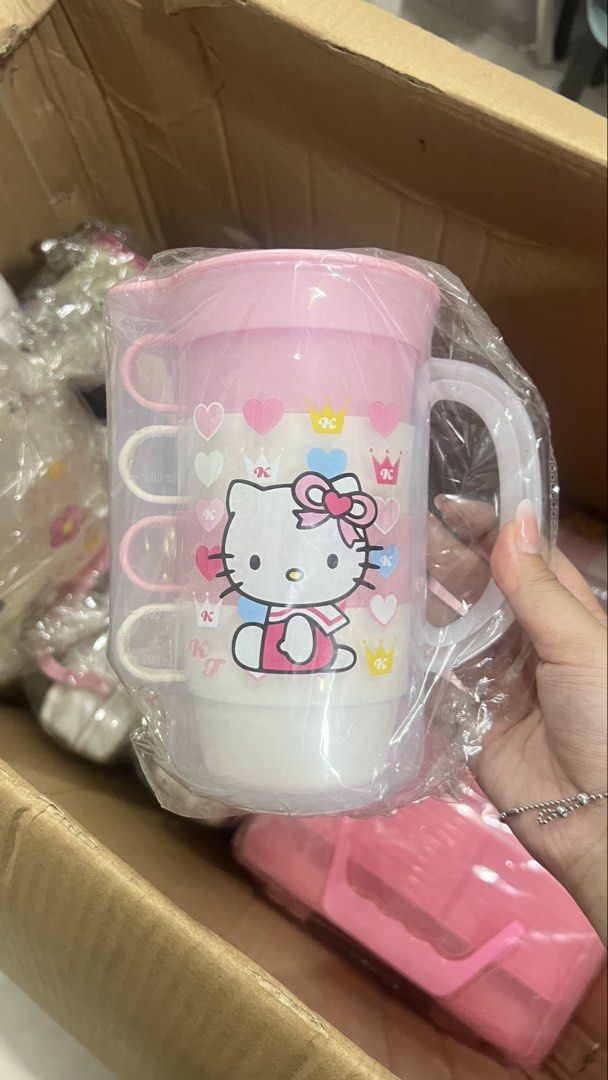 Hello Kitty Pitcher Cup Set (Category: Coffee & Tea Tableware) located in Manila. Submitted by machib (Listing ID 1436589746, Image 2). Description: - Kitty drinkware set - Includes: Pitcher with lid and 3 stackable cups - Features: Pink and white color scheme with Kitty designs - Pitcher: Has a handle - Cups: Have handles - Condition: Brand new, still in original packaging - have 3pcs available.
