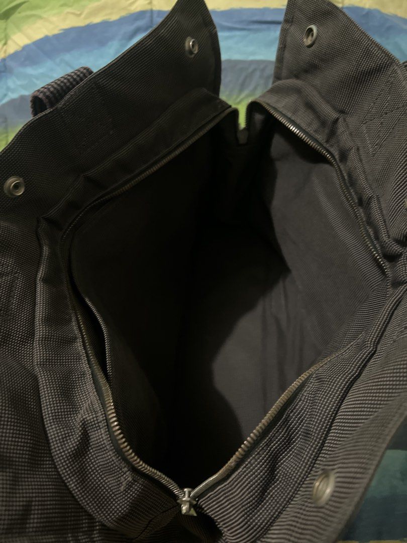 Hermes Herline Tote Bag (Category: Luxury Bags & Wallets) located in Pasay City. Submitted by damoreluxe (Listing ID 1436540184, Image 3). Description: - please self authenticate Hermes Herline black/gray tote bag - Black canvas exterior with leather accents - Spacious main compartment with zipper closure - Interior pocket included - Top handle for carrying - Secure snap closure - Hermes logo visible on interior label and snap button.