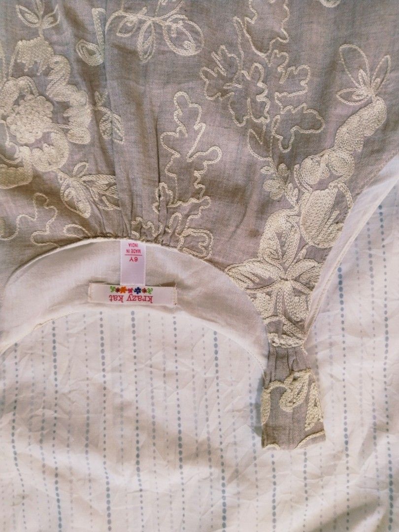 Krazy Kat Embroidered Dress (Category: Babies & Kids Fashion) located in Pasig City. Submitted by babylove2003 (Listing ID 1436504189, Image 3). Description: Beautiful dress from Krazy Kat, size 6Y (may fits 8Y petit). Features intricate floral embroidery and a layered ruffle hem. The dress has a sleeveless design with a round neckline. Made in India. The dress has a light beige color and light linen fabric with inner..