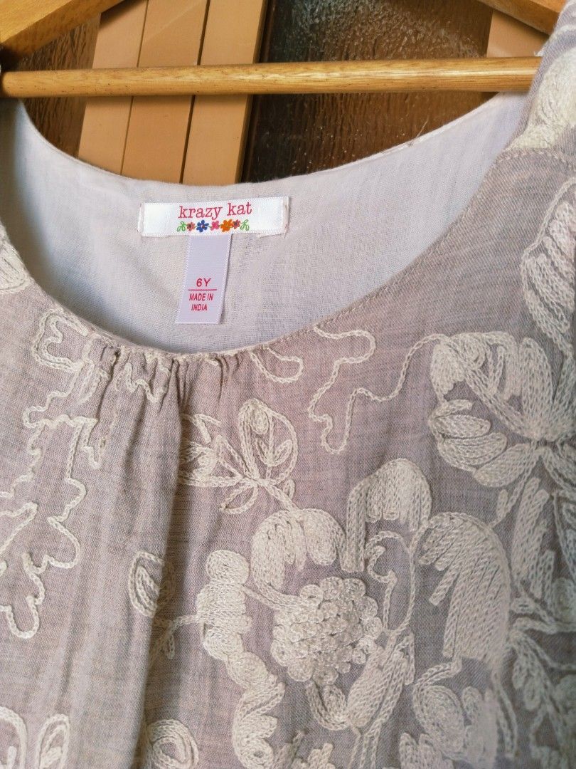 Krazy Kat Embroidered Dress (Category: Babies & Kids Fashion) located in Pasig City. Submitted by babylove2003 (Listing ID 1436504189, Image 2). Description: Beautiful dress from Krazy Kat, size 6Y (may fits 8Y petit). Features intricate floral embroidery and a layered ruffle hem. The dress has a sleeveless design with a round neckline. Made in India. The dress has a light beige color and light linen fabric with inner..