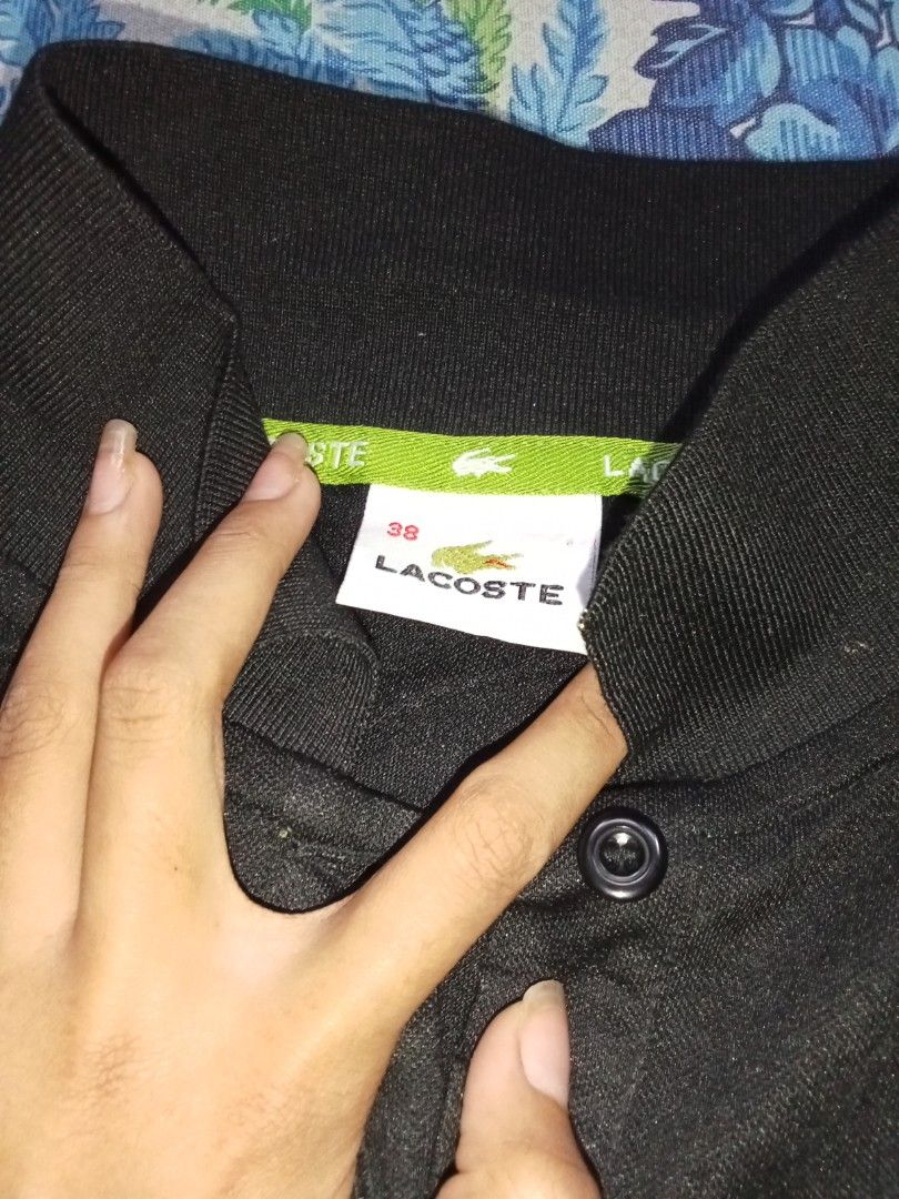 Lacoste Black Polo Shirt (Category: Tshirts & Polo Shirts ) located in Manila. Submitted by royal_jessamaelamoste (Listing ID 1436527217, Image 3). Description: - Classic black Lacoste polo shirt - Features the iconic green crocodile logo - Collared neckline with three buttons - Size: 38 - Comfortable fabric - Perfect for casual wear.