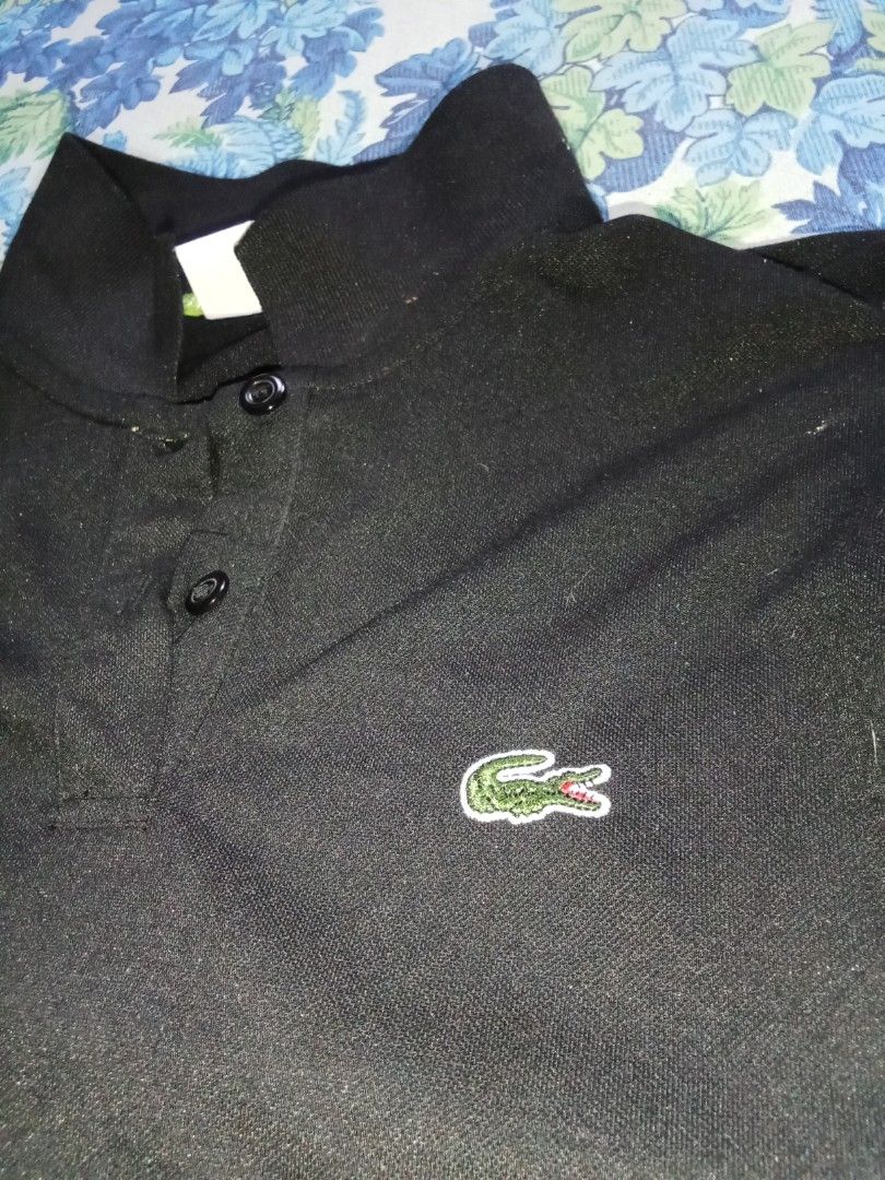 Lacoste Black Polo Shirt (Category: Tshirts & Polo Shirts ) located in Manila. Submitted by royal_jessamaelamoste (Listing ID 1436527217, Image 2). Description: - Classic black Lacoste polo shirt - Features the iconic green crocodile logo - Collared neckline with three buttons - Size: 38 - Comfortable fabric - Perfect for casual wear.