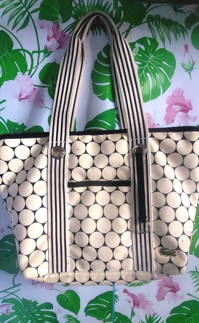 Lacoste Golf Ball Print Shopping Bag (Category: Tote Bags) located in Quezon City. Submitted by ahnna14 (Listing ID 1436531583, Image 1). Description: - Lacoste tote bag - Unique golf ball print design - Black and white striped handles - Black trim - Exterior pocket still negotiable..