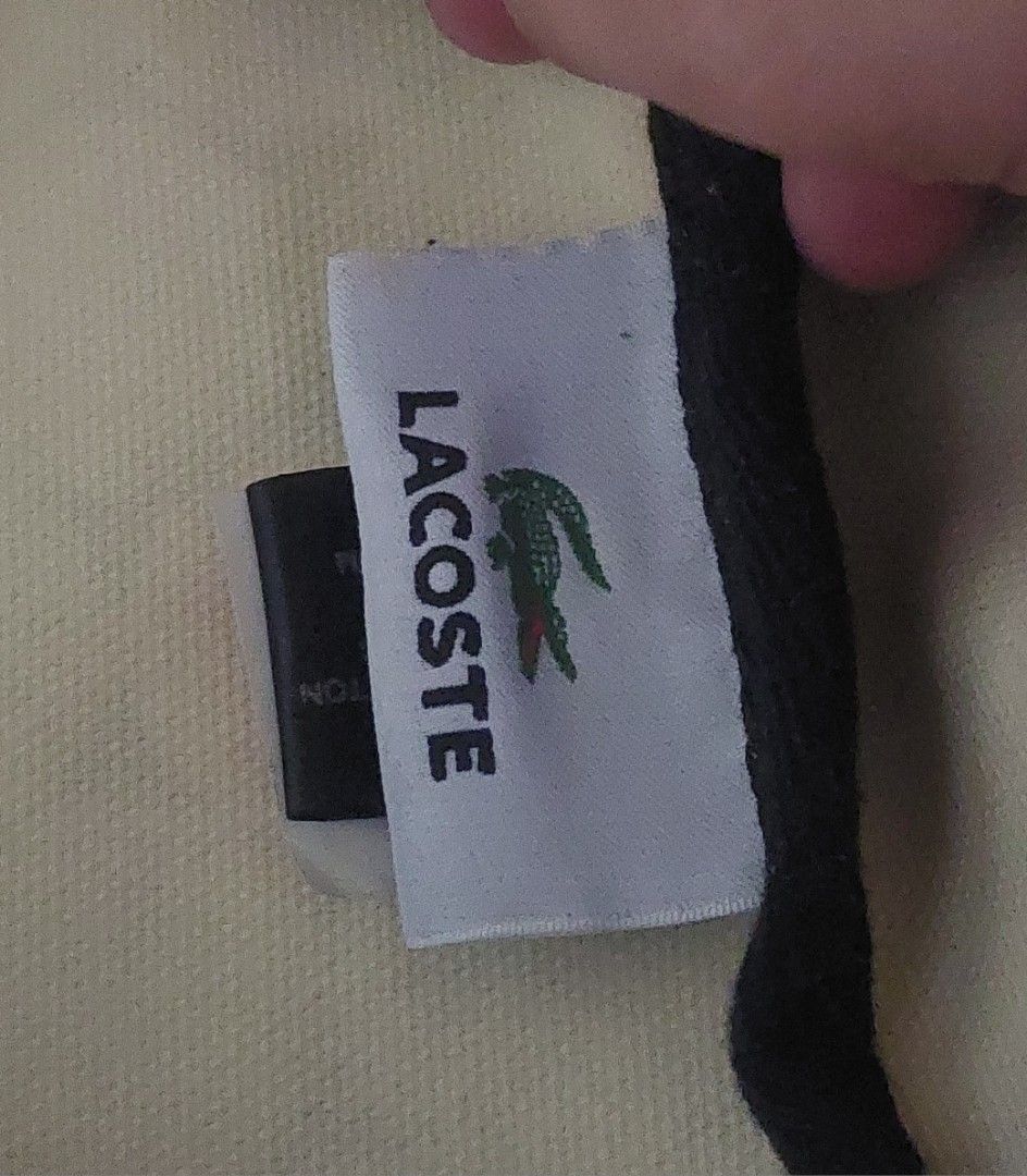 Lacoste Golf Ball Print Shopping Bag (Category: Tote Bags) located in Quezon City. Submitted by ahnna14 (Listing ID 1436531583, Image 2). Description: - Lacoste tote bag - Unique golf ball print design - Black and white striped handles - Black trim - Exterior pocket still negotiable..