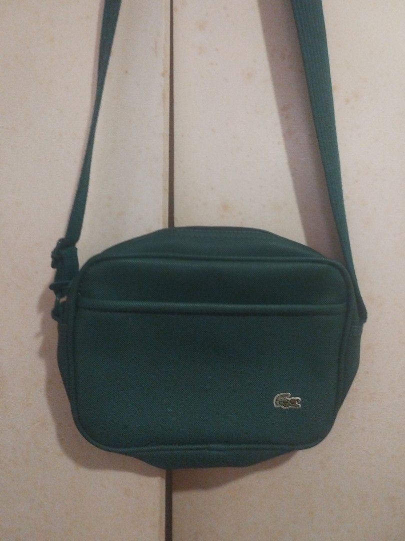 Lacoste Green Crossbody Bag (Category: Cross-body Bags) located in Pasig City. Submitted by maxipie (Listing ID 1436522722, Image 1). Description: - Lacoste crossbody bag - Vibrant green color - Main compartment - Front pocket - Adjustable strap - Interior Lacoste label - Stylish and classic design 📍 Location: Pasig.