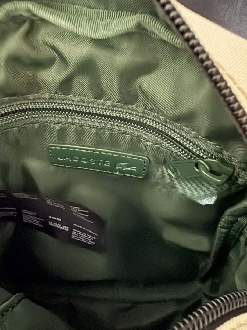 Lacoste Men's Classic Crossbody Bag (Category: Sling Bags) located in Quezon City. Submitted by lhiz.lhiz (Listing ID 1436551283, Image 1). Description: - Lacoste crossbody bag - Beige exterior, black strap - Zippered main compartment - Interior pocket - Lacoste logo on front and inside - Includes tag.