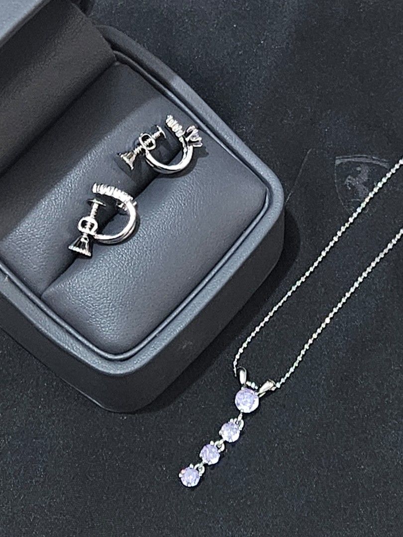 Lavender Cubic Earrings & Choker Necklace (Category: Necklaces) located in Muntinlupa City. Submitted by a.mnl (Listing ID 1436569717, Image 2). Description: - Silver jewelry set - Necklace with dangling purple stones - Matching earrings with unique design - Includes a black jewelry box - Perfect for any outfit From Hokkaido Japan .