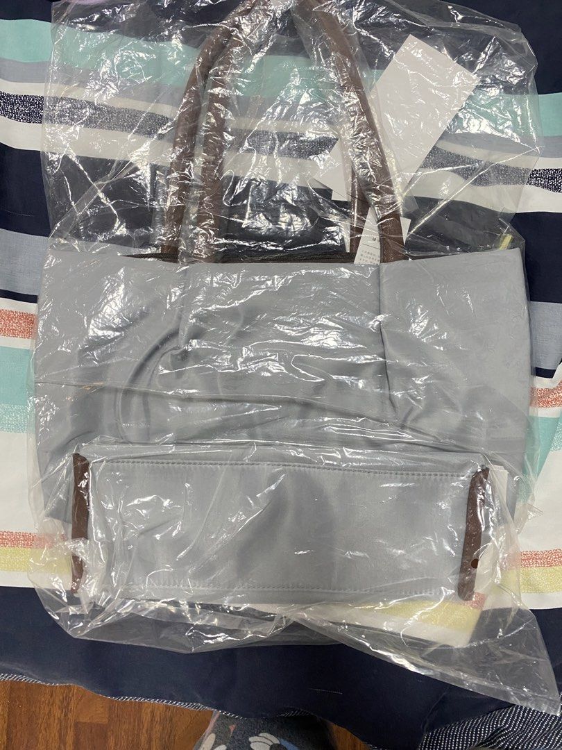 Legato Largo 2 way Tote Bag Medium Gray (Category: Tote Bags) located in Cavite. Submitted by prelovedclothesofzoe (Listing ID 1436601094, Image 2). Description: - Brand new grey tote bag - Features brown handles - Simple design - Spacious interior - Button closure - Includes original packaging - Comes with a tag featuring Japanese characters - Ideal for everyday use.