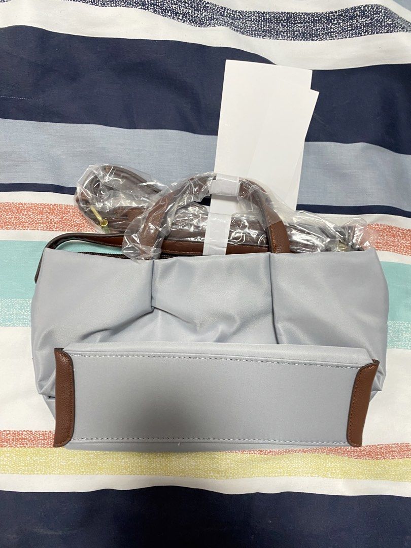 Legato Largo Mini Shoulder bag light grey (Category: Shoulder Bags) located in Cavite. Submitted by prelovedclothesofzoe (Listing ID 1436600516, Image 2). Description: - Light grey shoulder bag - Brown leather accents - Detachable shoulder strap - Top handles - Gold-colored clasp - New with tags.