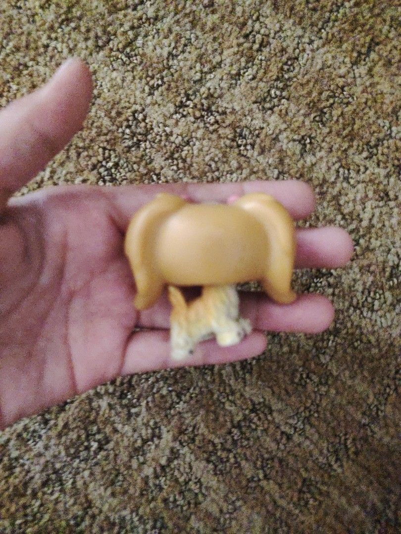 Littlest Pet Shop Dog Figure (Category: Figurines & Statues) located in Subic. Submitted by booley (Listing ID 1436474898, Image 3). Description: - Littlest Pet Shop dog figure - Tan body - Light brown head and ears - Green eyes - Pink bow - Small plastic figure - Sitting position.