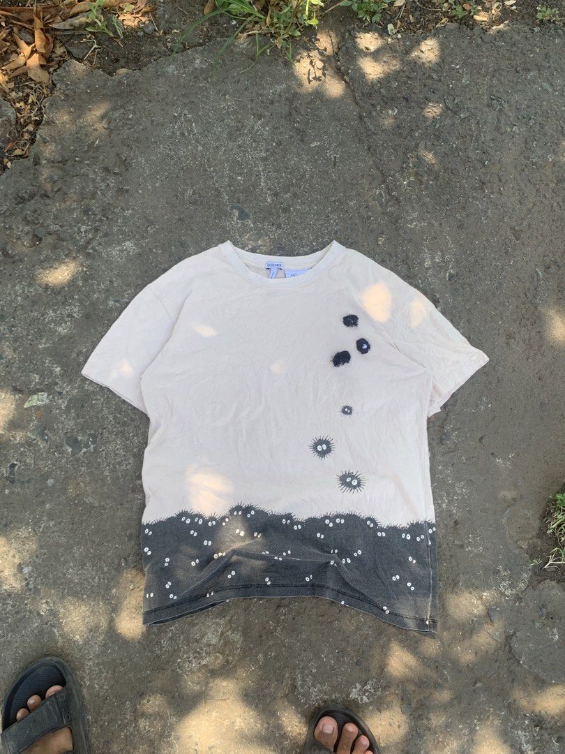 Loewe x Spirited Away T-shirt (Category: Tshirts & Polo Shirts ) located in Manila. Submitted by hiddenthrift_co (Listing ID 1436521874, Image 1). Description: - Loewe T-shirt with a Spirited Away-inspired design. - Features a light-colored upper section with black soot sprites. - Dark gray lower section with white eyes. - Classic crew neck and short sleeves. - Includes the Loewe logo on the collar..