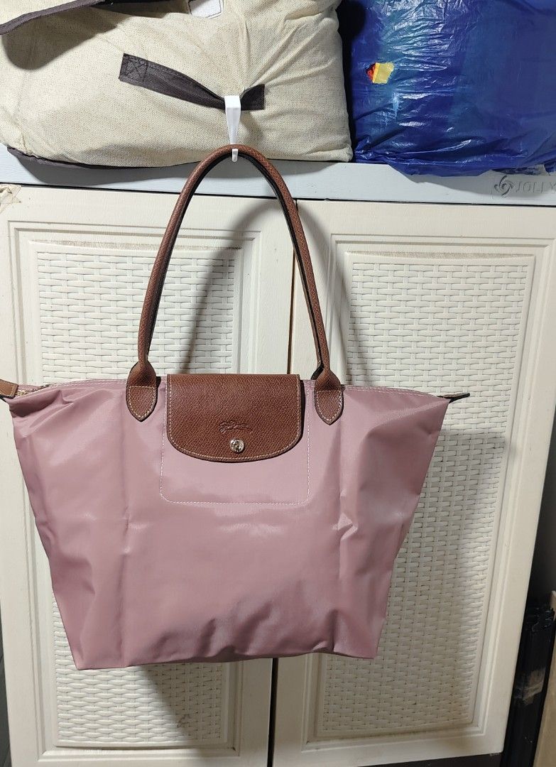 Longchamp Le Pliage Tote Bag (Category: Luxury Bags & Wallets) located in Caloocan City. Submitted by casseyann26-05661 (Listing ID 1436634844, Image 2). Description: - Longchamp Le Pliage tote bag. - Available colors: Gray, Pink, Navy Blue, Yellow. - Features: Leather handles, flap closure. - Versatile and stylish design. - Ideal for everyday essentials..