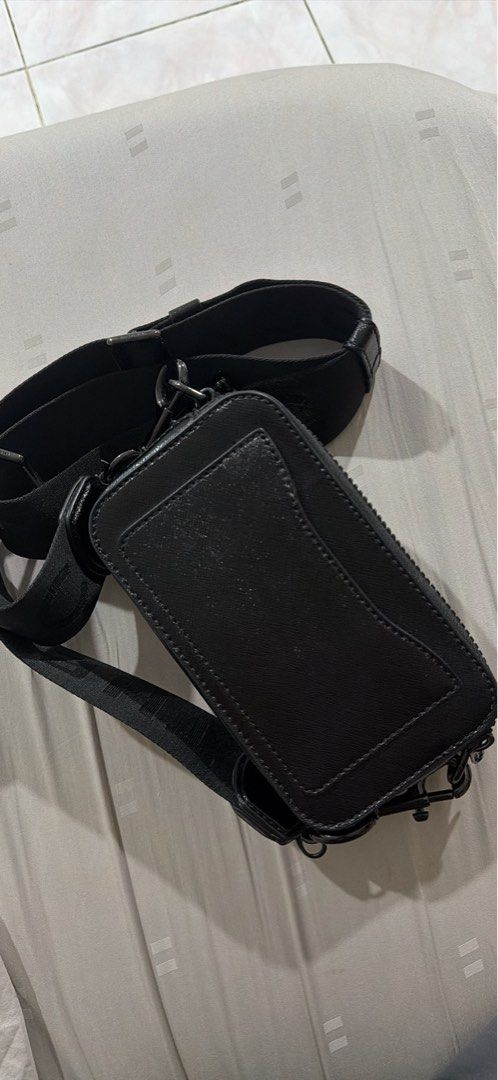 Marc Jacobs The Snapshot Bag (Category: Luxury Bags & Wallets) located in Manila. Submitted by miles_nier (Listing ID 1436635622, Image 2). Description: - Authentic Marc Jacobs Snapshot bag - Classic black color - Crossbody style with adjustable strap - Rectangular shape - Features the Marc Jacobs logo - Secure zipper closure - Includes a small interior pocket - Crafted from textured leather Just missing one of the zippers but otherwise new.