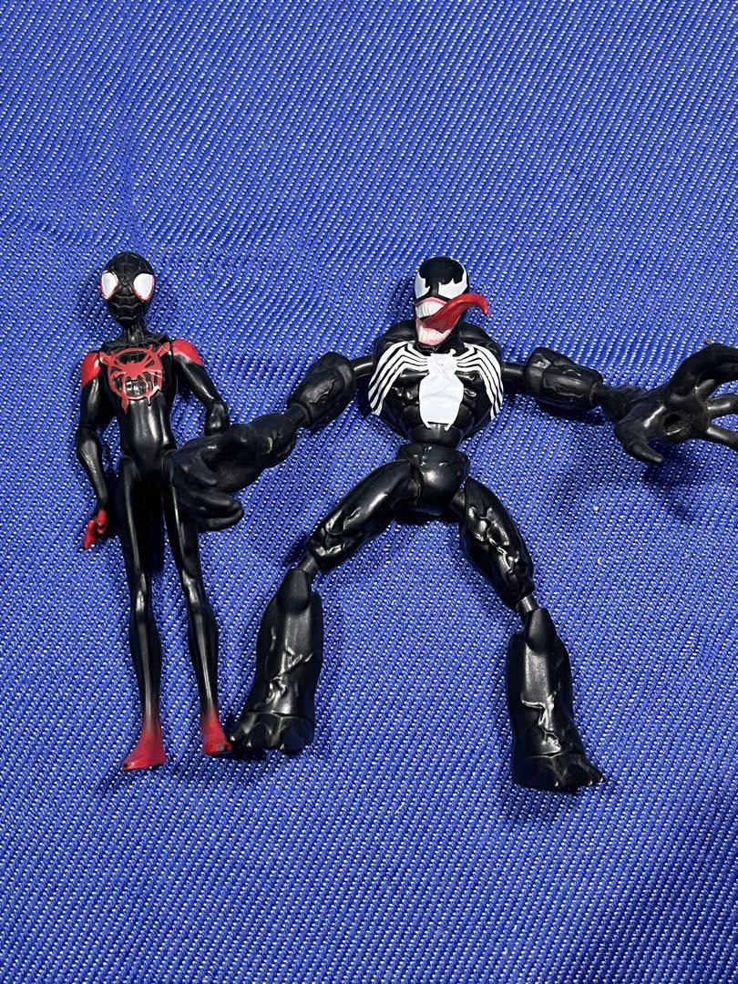 Marvel Spider-Man Miles Morales and Venom Figures (Category: Figurines & Statues) located in Cabanatuan. Submitted by isaiahave (Listing ID 1436471538, Image 1). Description: - Marvel action figures for sale! - Includes Miles Morales and Venom figures. - Miles Morales: Black and red suit. - Venom: Features white spider symbol on chest and back. - Both figures are in a standing pose. - Made of plastic..