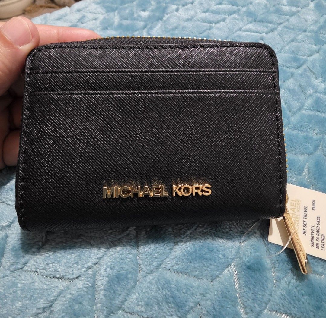 Michael Kors Jet Set Travel Zip Card Case (Category: Luxury Bags & Wallets) located in Mandaluyong City. Submitted by mlstuff28 (Listing ID 1436470525, Image 1). Description: - Brand new Michael Kors Jet Set Travel card case. - Color: Black - Material: Leather - Features: - Multiple card slots - Zippered compartment - Gold-tone zipper and logo - Condition: New with tags.