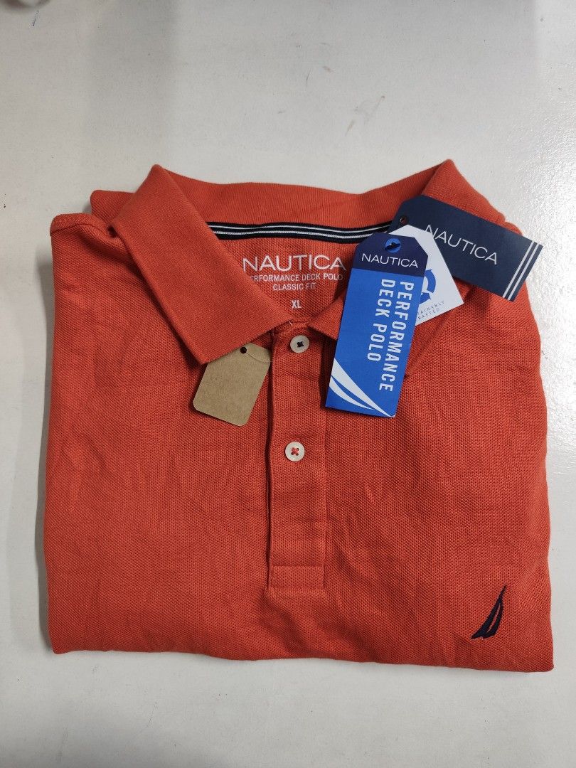 Nautica Performance Deck Polo Shirt XL (Category: Tshirts & Polo Shirts ) located in Compostela. Submitted by fashiondeamar (Listing ID 1436611736, Image 1). Description: - Nautica Performance Deck Polo Shirt - Color: Orange - Size: XL - Classic Fit - Made with sustainably crafted materials - Features the Nautica logo on the chest - Includes original tags - Made in Indonesia.