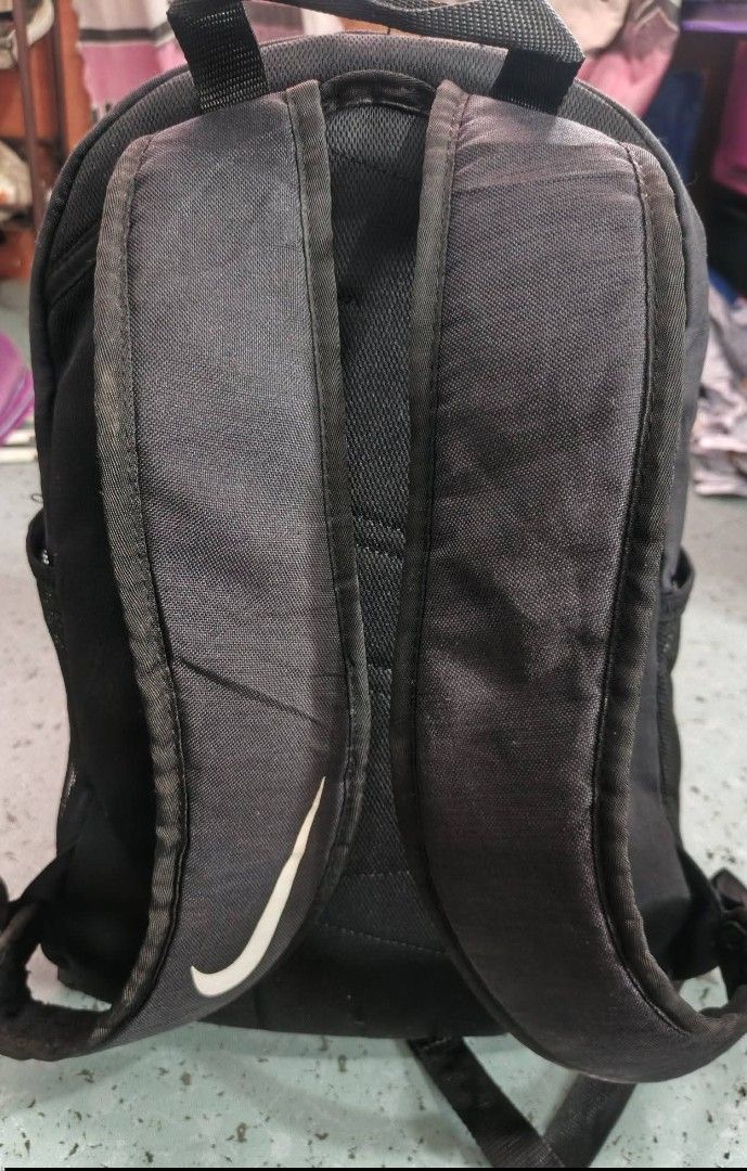 Nike Backpack (Category: Backpacks) located in San Carlos City. Submitted by dhong_abay_thrift (Listing ID 1436498233, Image 3). Description: - Black Nike backpack - White Nike logo - Main compartment - Front pocket - Side pockets - Adjustable shoulder straps - Durable fabric - Visible zippers.