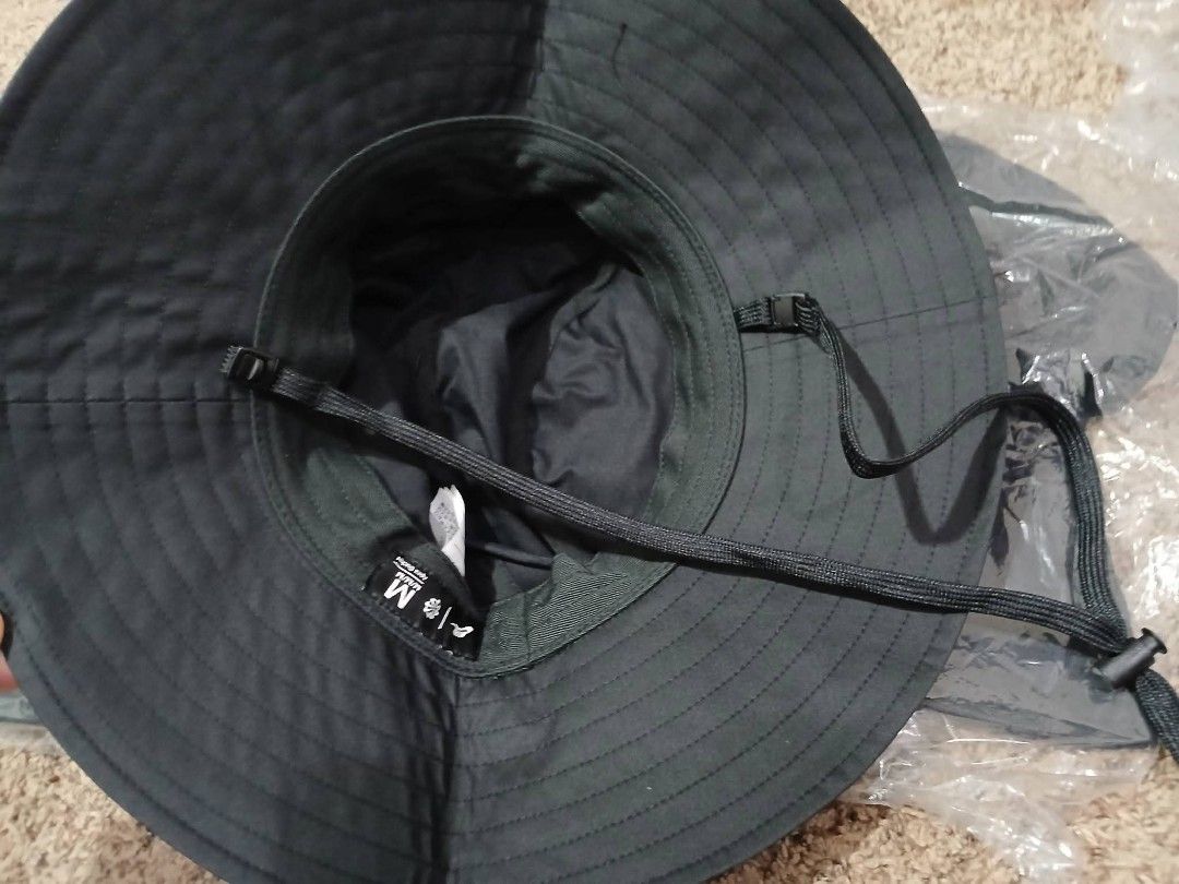 Nike Bucket Hat (Category: Caps & Hats) located in Bulacan. Submitted by jhenecisbacuel1 (Listing ID 1436507021, Image 3). Description: - Black Nike bucket hat - Adjustable chin strap - Wide brim for sun protection - Size M - Made of lightweight, possibly water-resistant material.