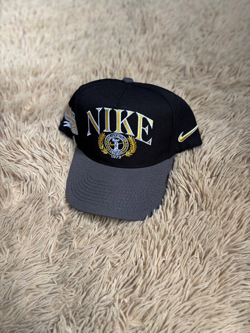 Nike Cap Black and Grey (Category: Caps & Hats) located in Quezon City. Submitted by nojthrift (Listing ID 1436509891, Image 1). Description: - Nike cap in black and grey - Embroidered Nike logo and "NIKE 1972" on the front - Curved brim - Adjustable strap at the back - Size: M/L - Yellow Nike swoosh on the side 850+ship only.