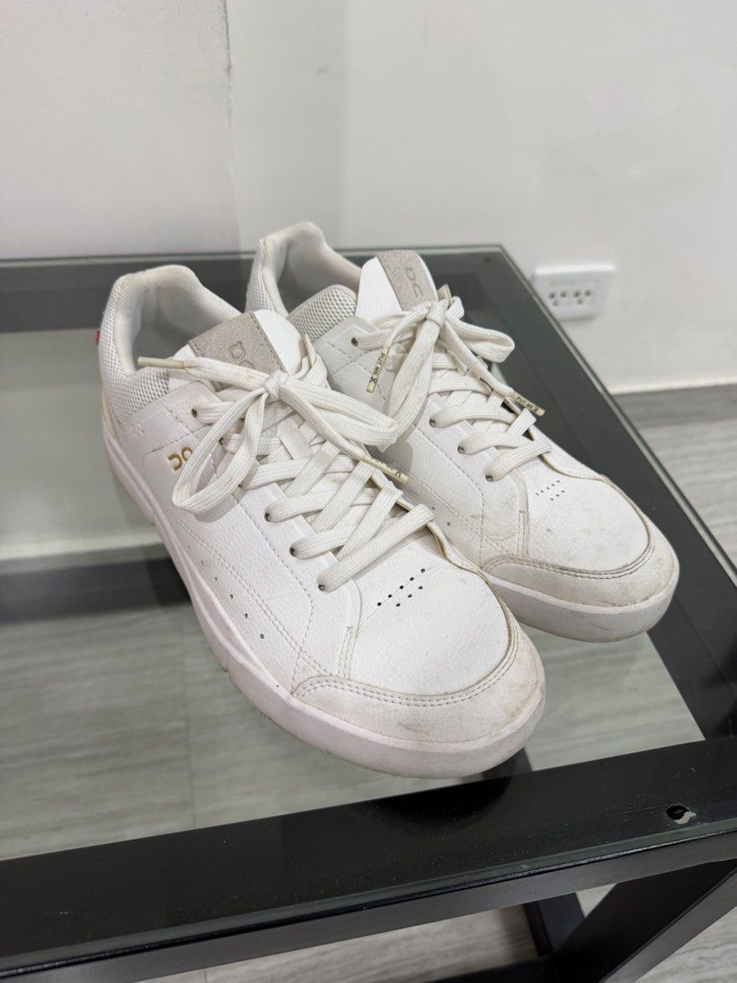 On Cloud True Roger Sneakers (Category: Sneakers) located in Mandaluyong City. Submitted by Lexphi (Listing ID 1436500876, Image 2). Description: - White On Cloud True Roger sneakers - Gold On logo detail - Mesh panel - Cream-colored sole - White laces.