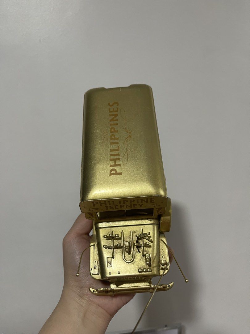 Philippine Jeepney Gold Miniature (Category: Vehicle & Diecast Models) located in Taguig. Submitted by supplementary (Listing ID 1436586689, Image 2). Description: - Gold-colored miniature jeepney. - Features 'Philippines' and 'Luzon Visayas Mindanao' text. - Made of metal. - Black wheels. - Highly detailed design. - Collectible item..