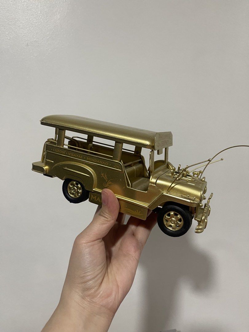 Philippine Jeepney Gold Miniature (Category: Vehicle & Diecast Models) located in Taguig. Submitted by supplementary (Listing ID 1436586689, Image 1). Description: - Gold-colored miniature jeepney. - Features 'Philippines' and 'Luzon Visayas Mindanao' text. - Made of metal. - Black wheels. - Highly detailed design. - Collectible item..