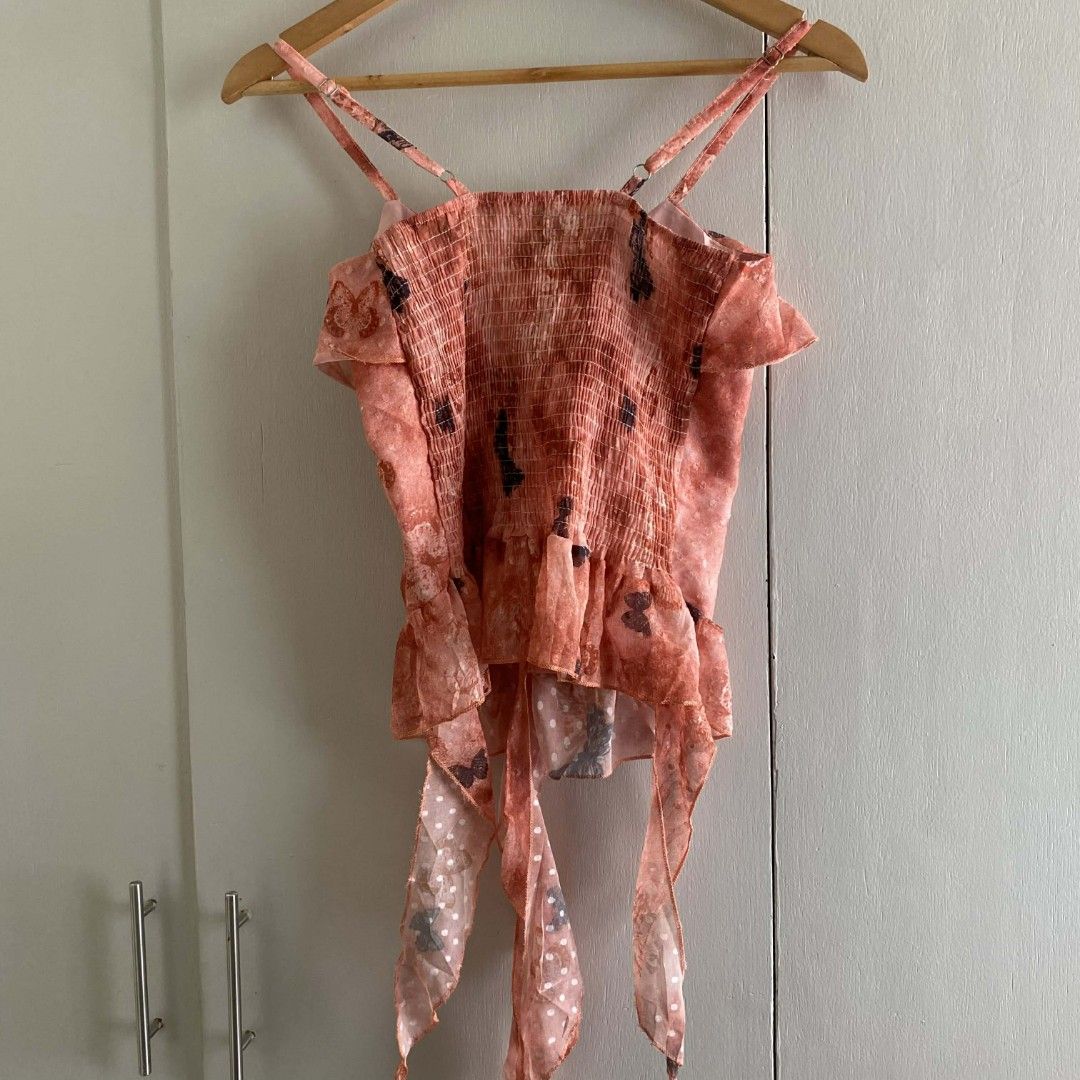 Pink Peach Butterfly Print Ruffle String Sleeveless Top (Category: Sleeveless) located in Manila. Submitted by cznclae (Listing ID 1436520267, Image 2). Description: best fit for size XS-S Bust: up to 32" ❔issue: sf mm & luzon 41 pesos if not rush via jnt 🗓️ check bio for next shipment sched PLEASE READ! ❗️PAYMENT FIRST via g/cash or Pabili service 🛒how to buy? make an offer, then send details for SF quotation feel free to ask q's. bump your me