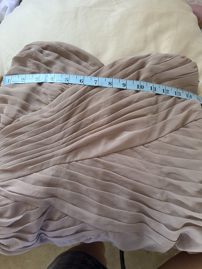 Pleated Strapless Nude Beige Long Gown (Category: Evening dresses & gowns) located in Tarlac. Submitted by berrymii (Listing ID 1436508246, Image 2). Description: - Strapless dress in a light brown color - Features a pleated bodice - Flowing skirt design - Button closure at the back - Perfect for special occasions -Customized, bought for 5k -Used once for a wedding -Not padded -Needs dry clean -Issue: May tastas sa ilalim but di naman halata 📍Lo
