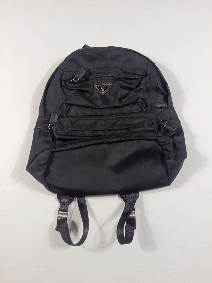 Prada Black Backpack (Category: Luxury Bags & Wallets) located in Manila. Submitted by wildtiger.f054f7 (Listing ID 1436599371, Image 1). Description: - Authentic Prada backpack - Color: Black - Material: Nylon - Features: Multiple compartments, adjustable straps, top handle - Closure: Zippered - Design: Prada logo on front, patterned interior lining.