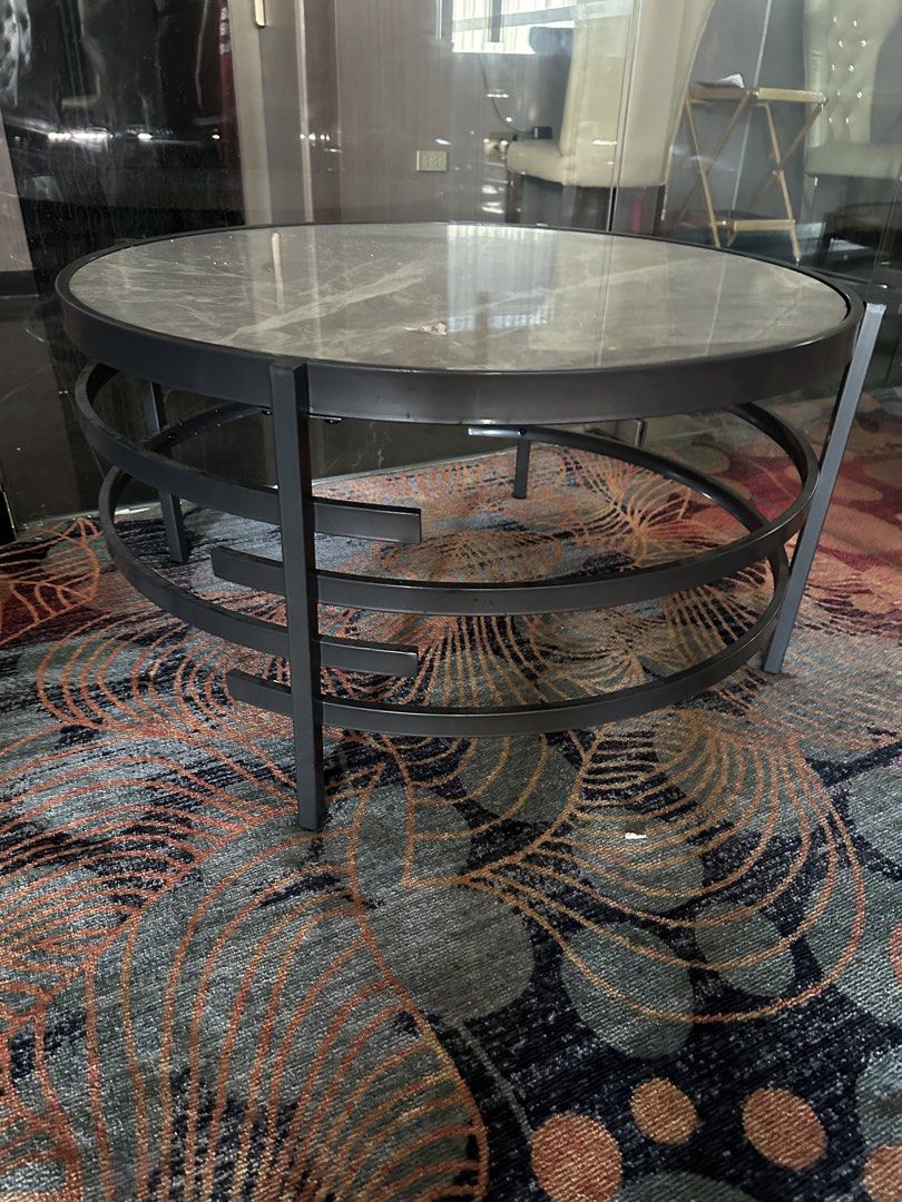 Round Coffee Table with Marble Top (Category: Tables & Sets) located in Mandaue City. Submitted by m1917 (Listing ID 1436512142, Image 3). Description: - Round coffee table - Marble-look top - Black metal frame - Unique spiral leg design - Modern style - Sturdy and stable - Ideal for drinks, books, or decor.