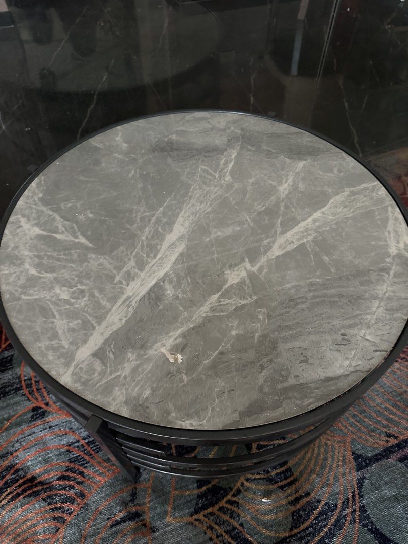 Round Coffee Table with Marble Top (Category: Tables & Sets) located in Mandaue City. Submitted by m1917 (Listing ID 1436512142, Image 2). Description: - Round coffee table - Marble-look top - Black metal frame - Unique spiral leg design - Modern style - Sturdy and stable - Ideal for drinks, books, or decor.