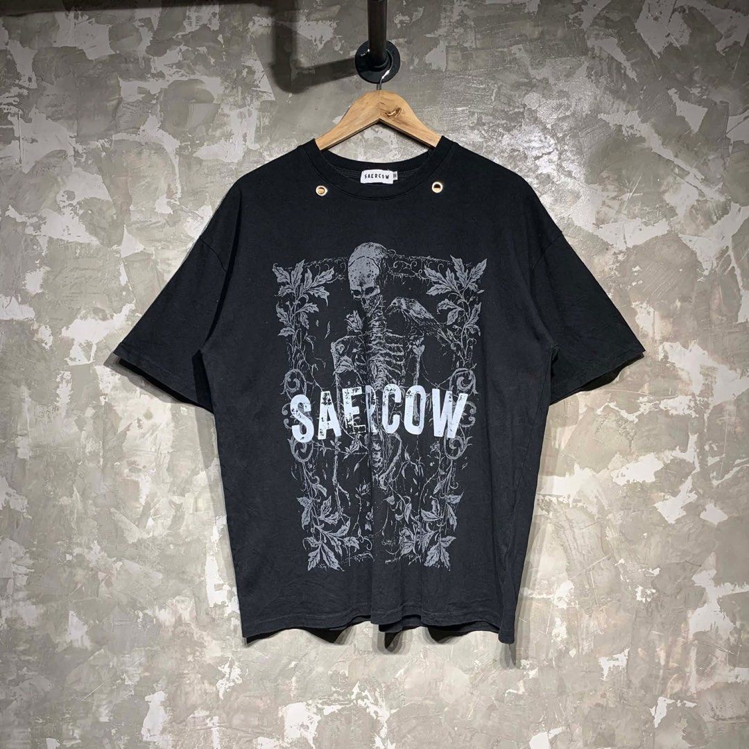 Saercow Skeleton Graphic T-shirt (Category: Tshirts & Polo Shirts ) located in Manila. Submitted by notjustfits (Listing ID 1436642321, Image 1). Description: SAERCOW ◾ Dimes: 23×28 ◾ Condition: Excellent condition ◾ Flaw/s: no issue - Black Saercow T-shirt - Features a skeleton graphic - Crew neck design - Includes metal eyelets - Made of 100% cotton - Brand label is visible - Size not indicated.
